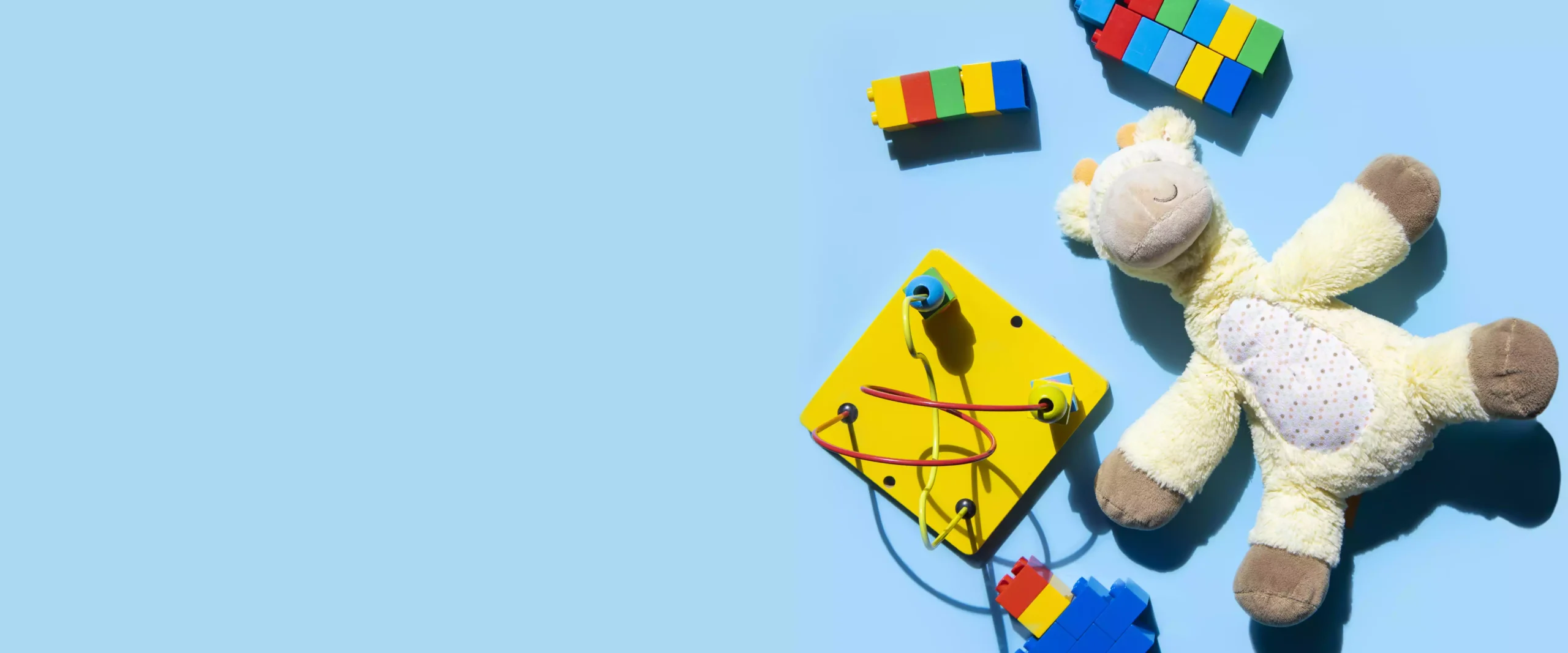 children-s-educational-toys-are-scattered-blue-background-top-view-flat-lay-banner